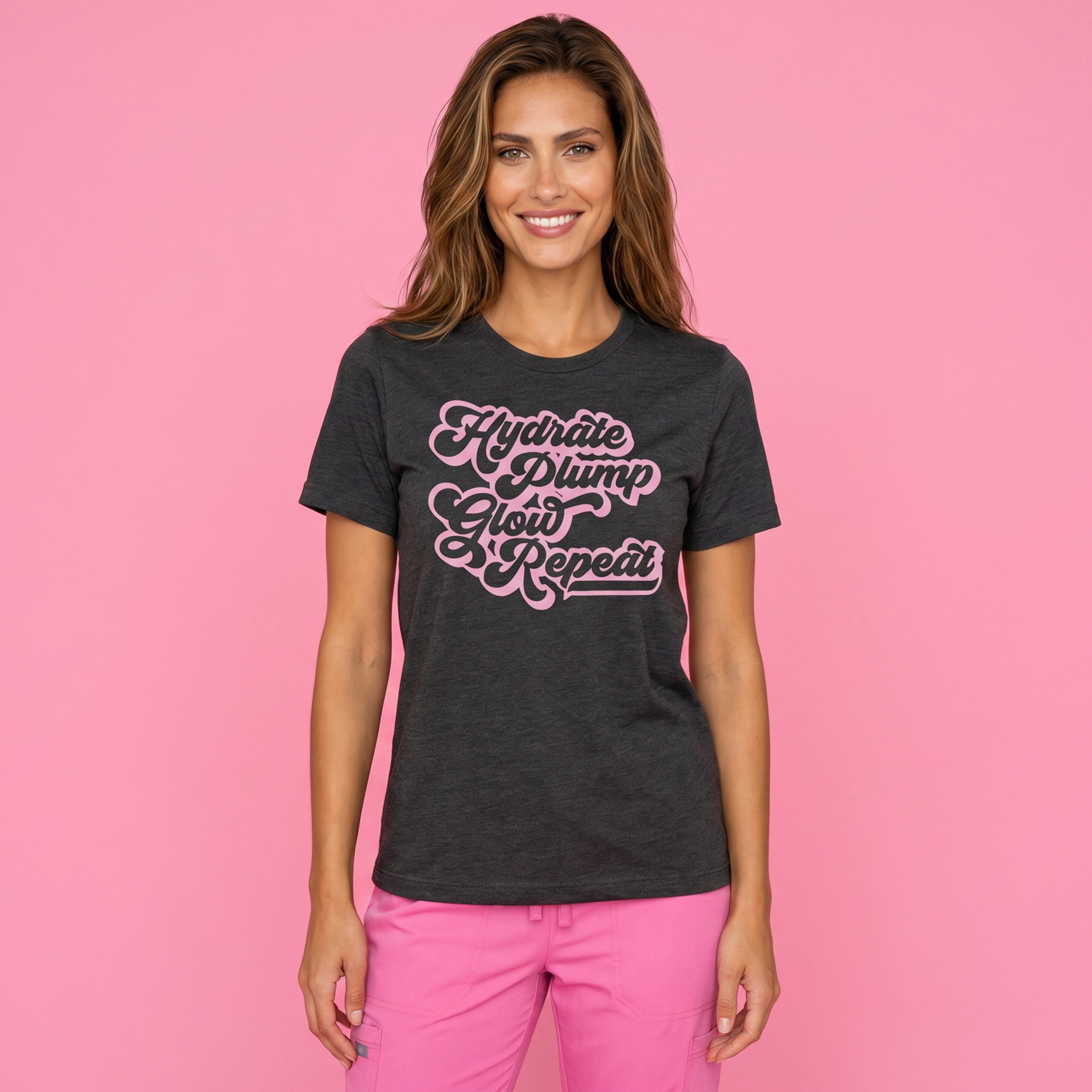 A woman on a pink background wearing Fix Studios Hydrate Plump Glow Repeat t-shirt for medspa professionals, injectors and Botox/medspa fans