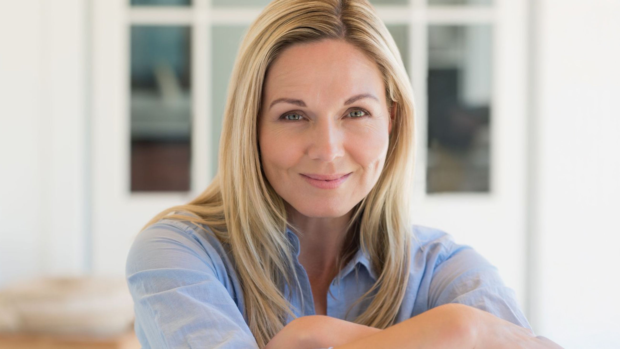 A woman in her 40s smiling