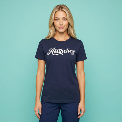 A woman wears a navy blue Aesthetics Department t-shirt from Fix Studios for medspa professionals, injectors, and medspa fans