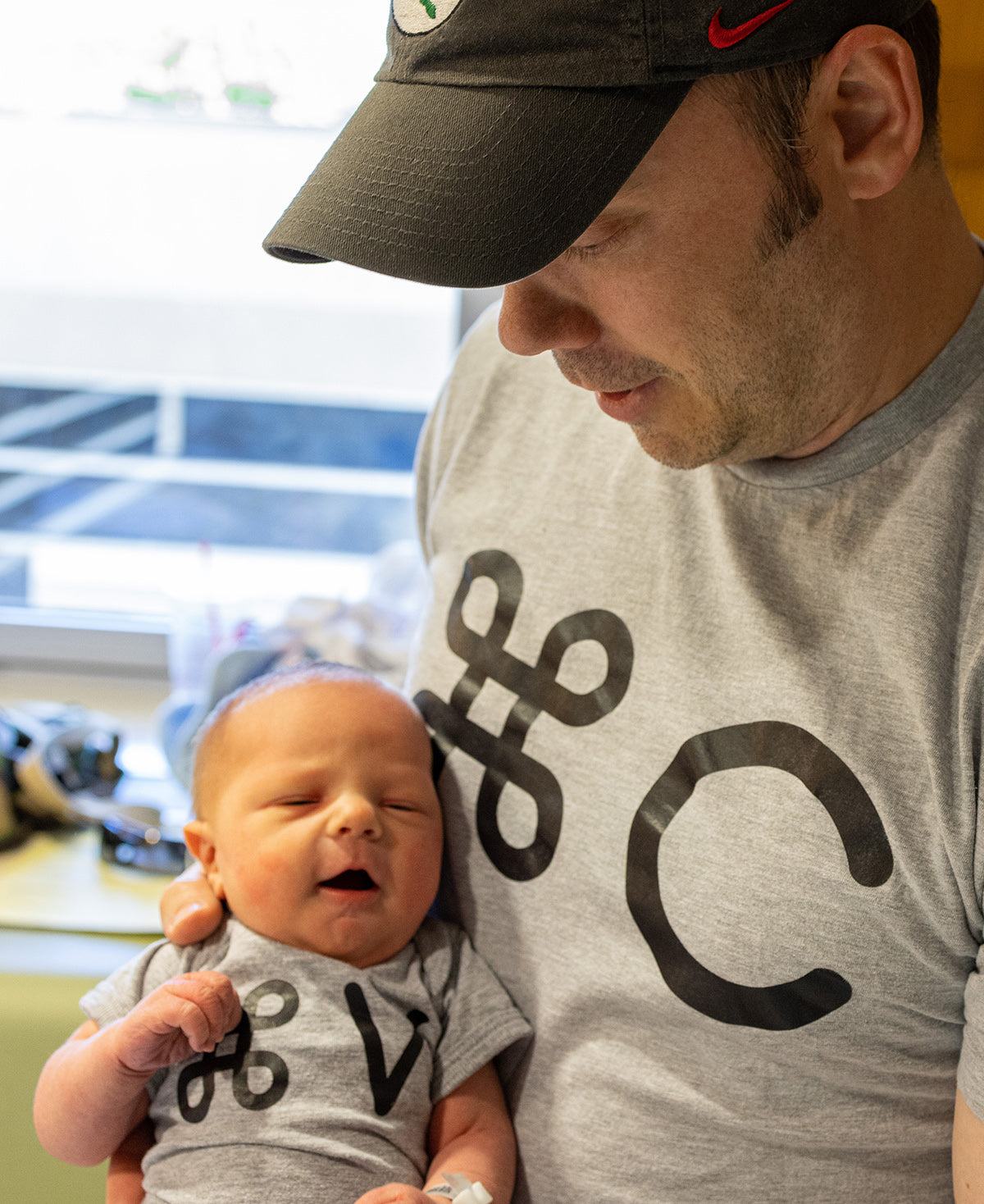 Andy Matre holding his newborn son in the hospital where Fix Studios was also born