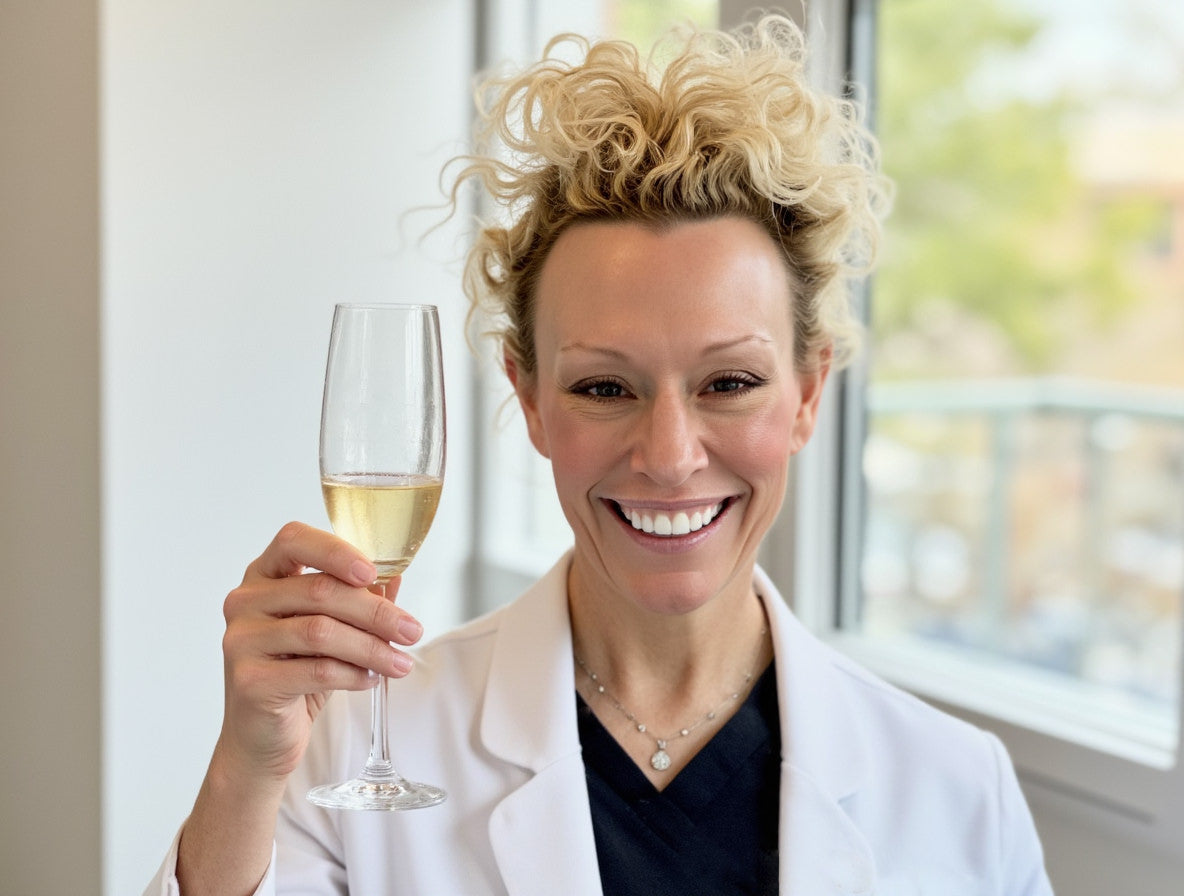 Dr Beth Matre raises a glass of champagne to toast the signature sales event