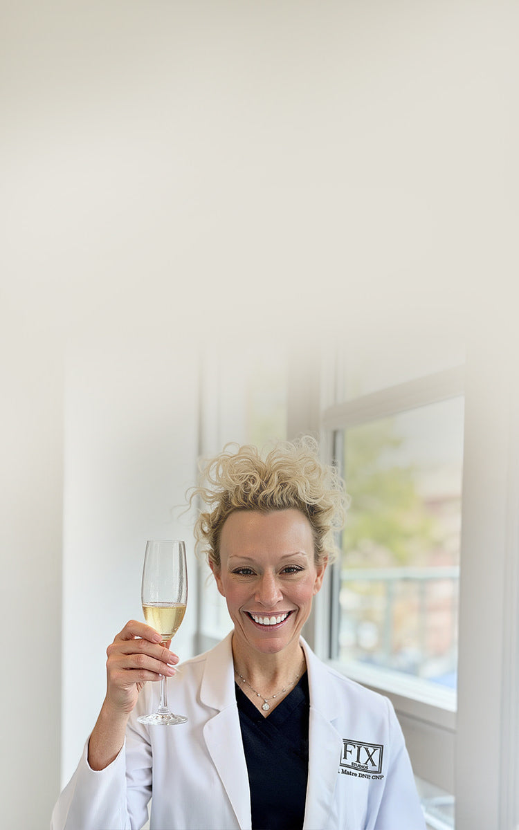 Dr Beth Matre holds a glass of champaign to toast the annual Fix Studios Signature Sales Event on October 24th 2026