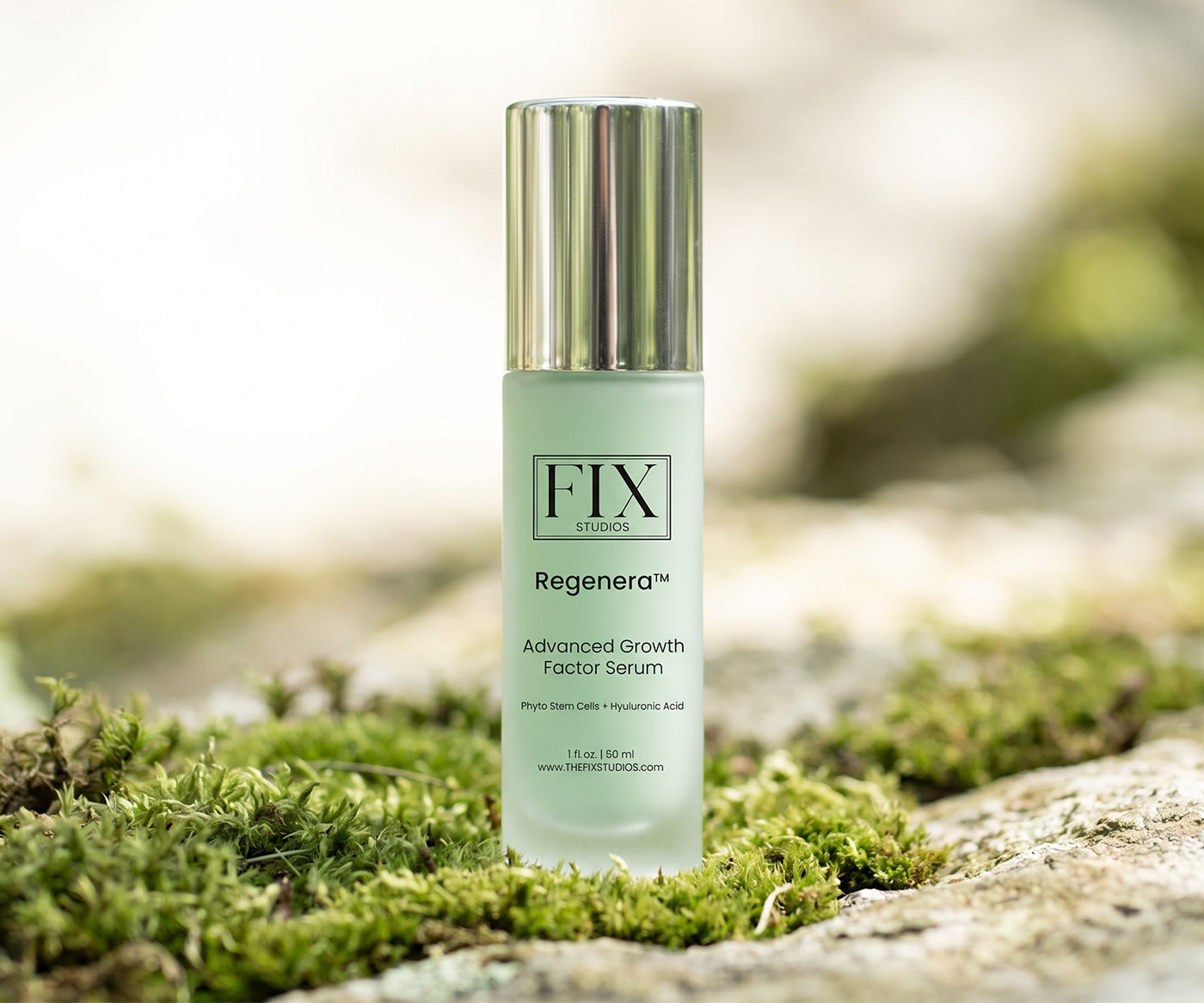 A bottle of Regenera™ Advanced Growth Factor Serum medical-grade anti-aging serum from Fix Studios sits on moss and rocks representing its plant-based formula
