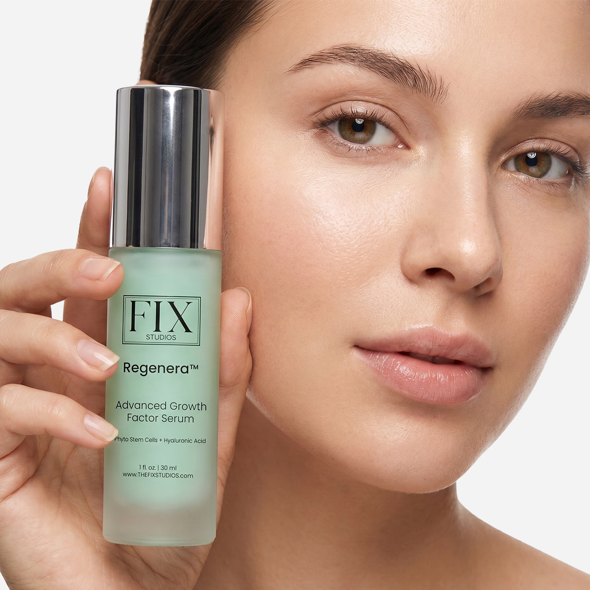 A woman holding a bottle of Regenera™ Advanced Growth Factor Serum - Medical-Grade anti-aging and recovery serum from Fix Studios